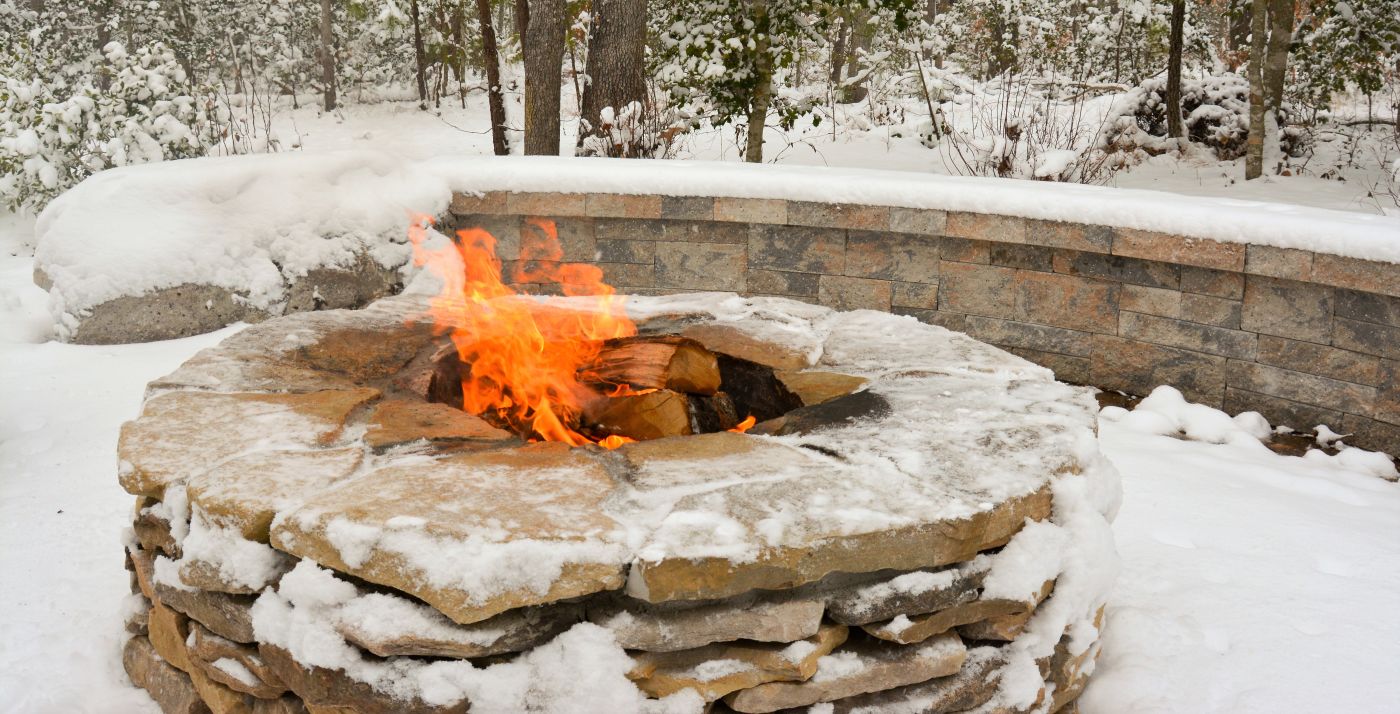 roaring fire inside the large fire pit during a snowy winter afternoon