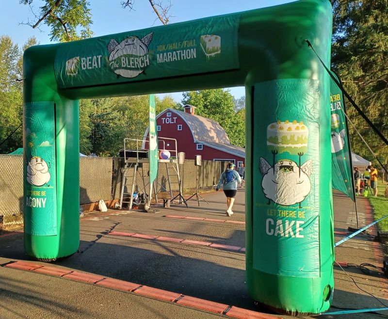 A green inflatable start and finish line arch