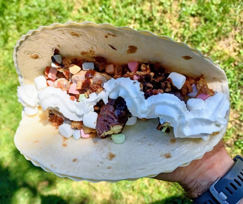 A tortilla filled with donuts, bacon and marshmallows