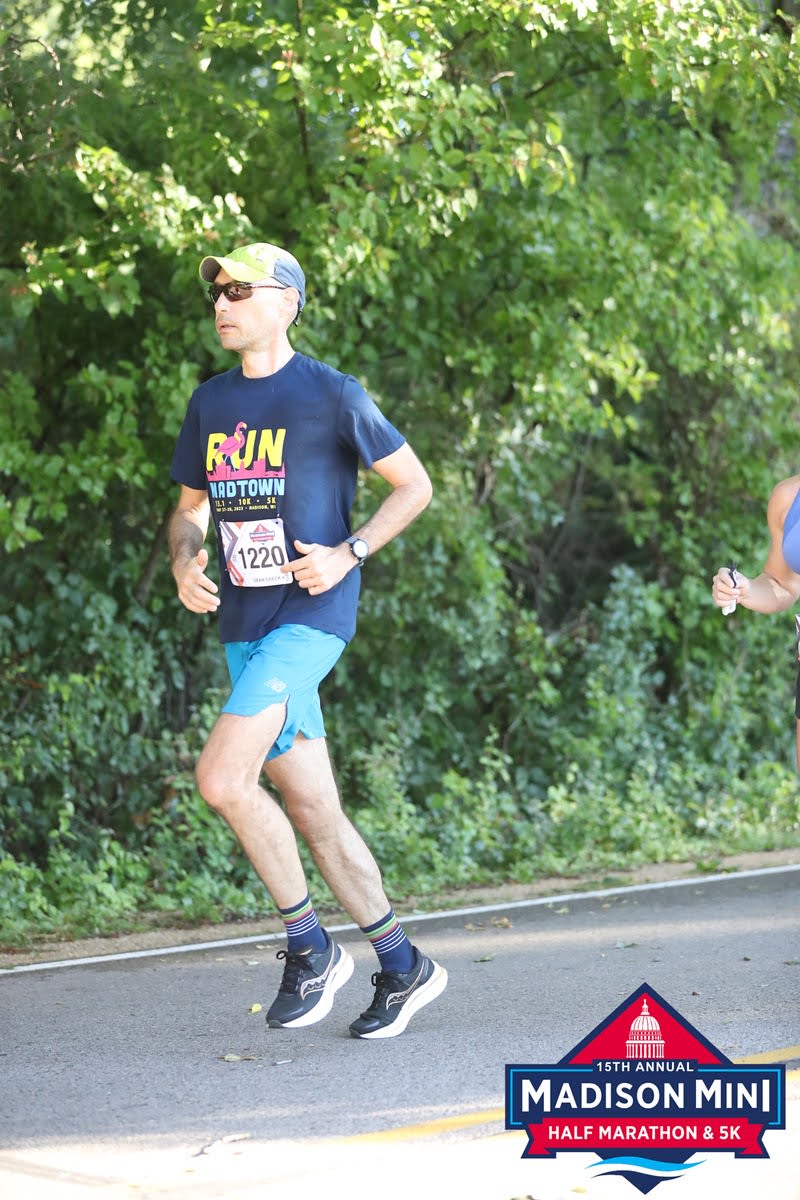 Blog author running in Madison Mini half marathon on in the UW Madison Arboretum