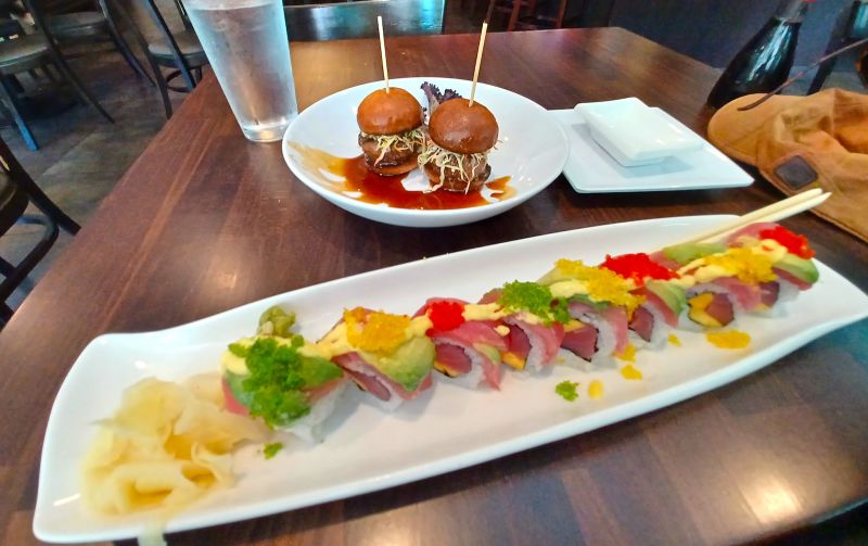 a photo of sushi and slider burgers
