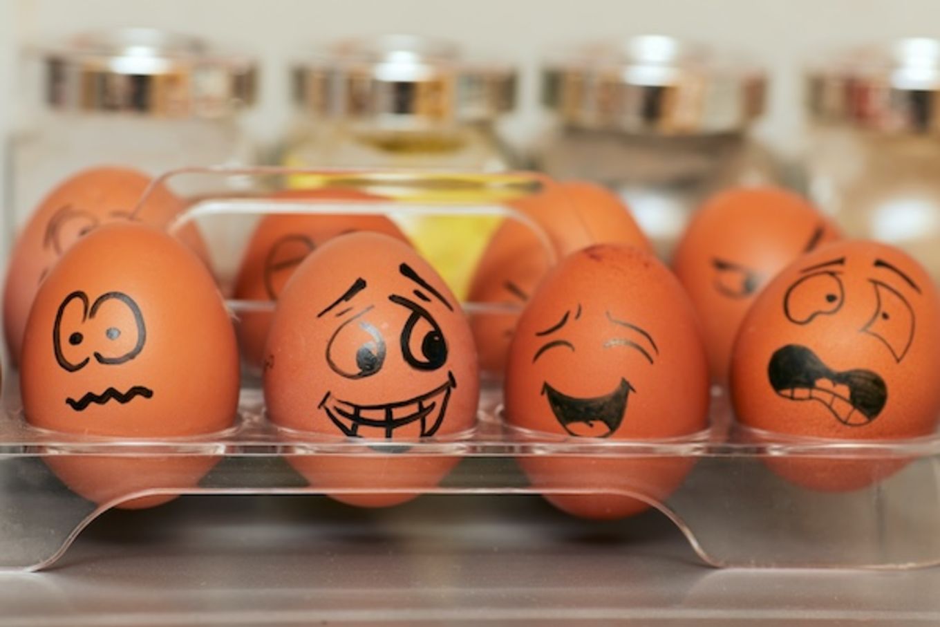 Some eggs with funny faces drawn on them expressing a wide range of emotion.