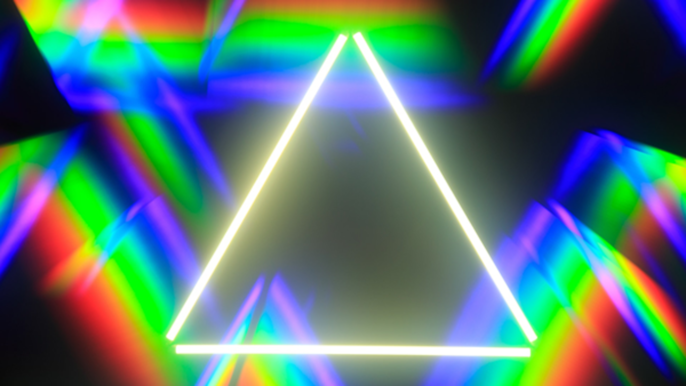 An incomplete triangle made of light that is hovering over a kaleidoscope looking background.
