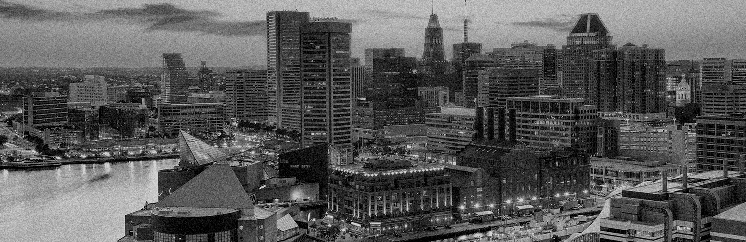 black and white panorama of buildings and waterfront in Baltimore, MD