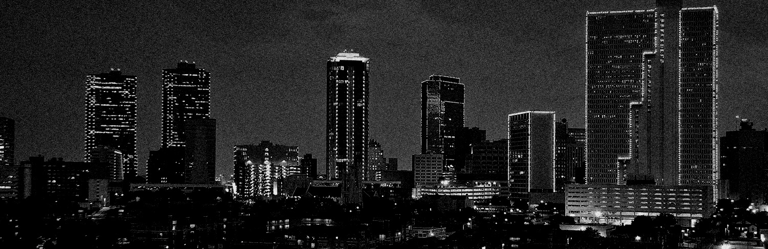 black and white panorama of buildings in Dallas, TX at night