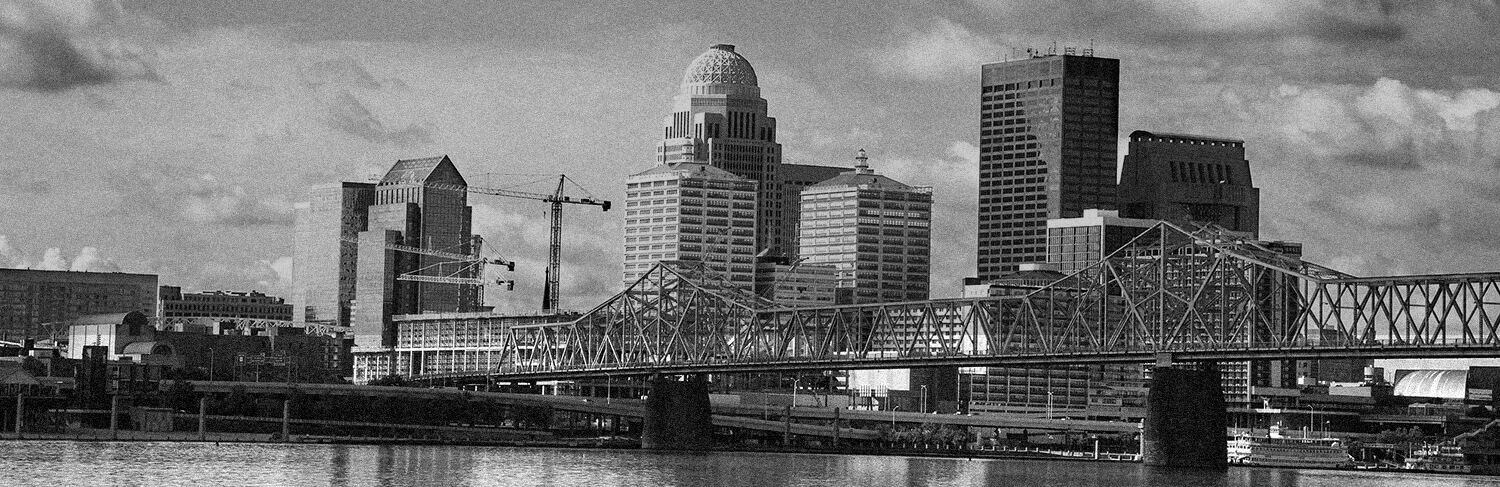 black and white panorama of buildings, bridge and river in Louisville, KY