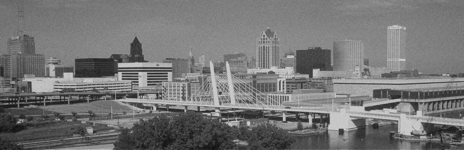 black and white panorama of buildings and water in Milwaukee, WI