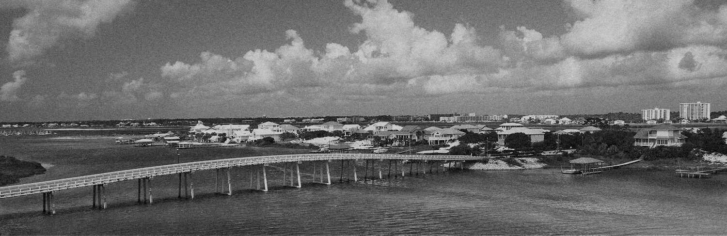 black and white panorama of waterfront and bridge in Orange Beach, AL