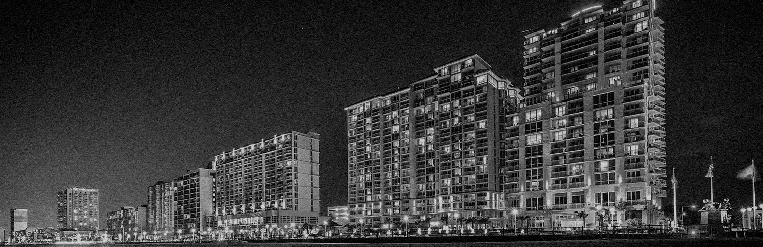 black and white panorama of buildings at night in Virginia Beach, VA