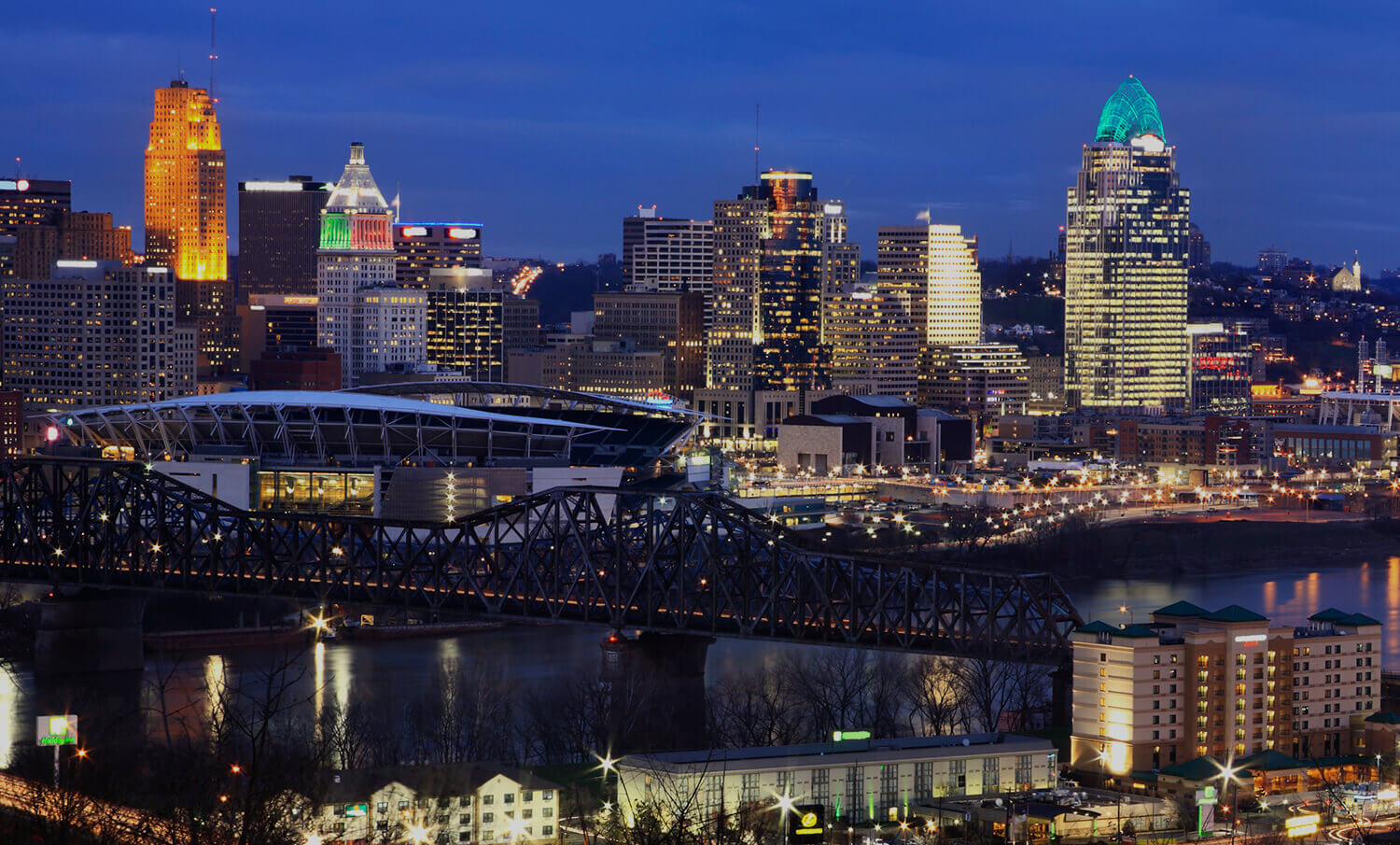 black and white panorama of buildings and river at night in Cincinnati, OH