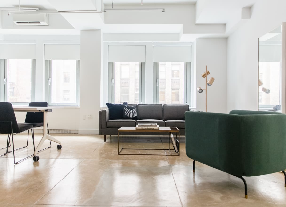 Bright Breather office space furnished with work table and chairs and lounge seating.