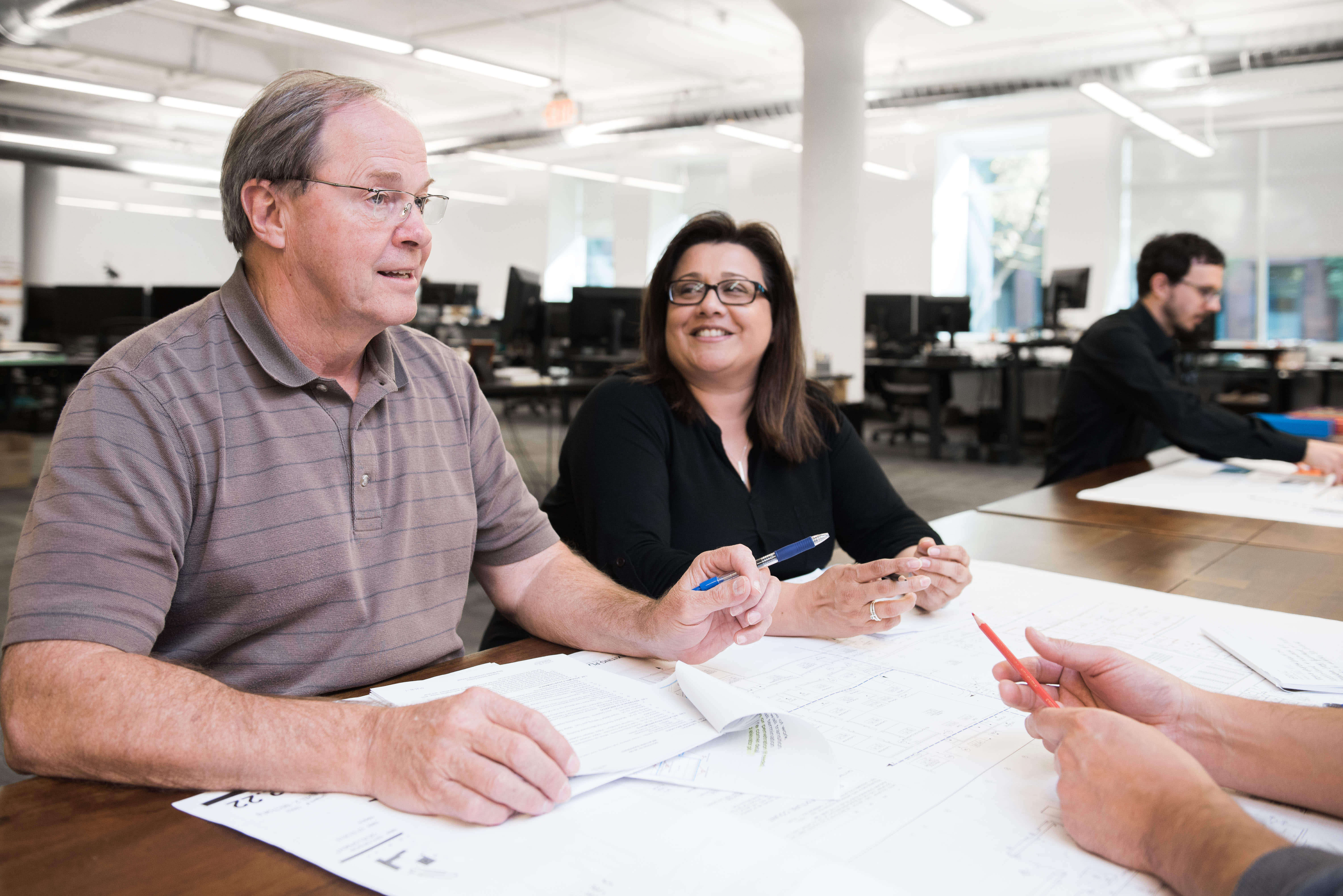 Kenneth (left) working with project team members