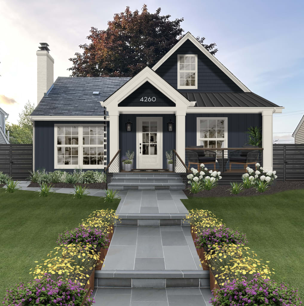 Dark navy blue cottage with chunky white trim, white front door, and black metal roof featuring one of our Benjamin Moore exterior paint colors 2024