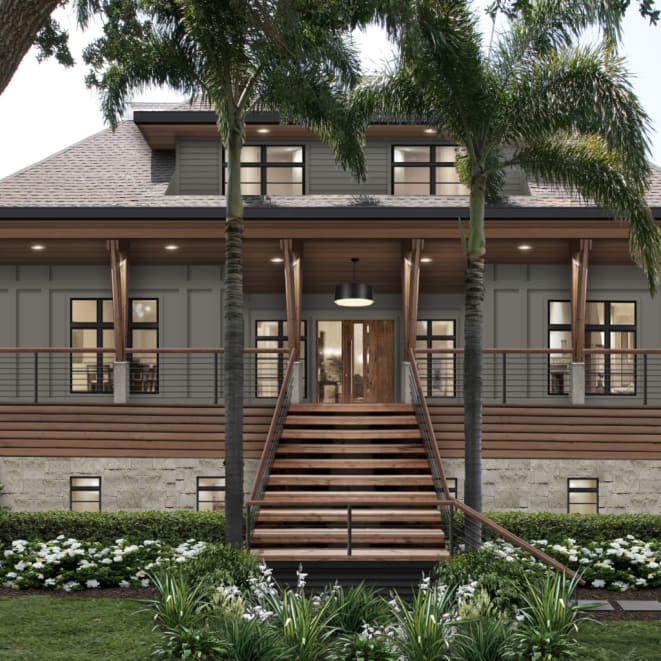 The exterior design of a coastal bungalow with a large porch featuring James Hardie siding in Aged Pewter, wood accents, and stone.