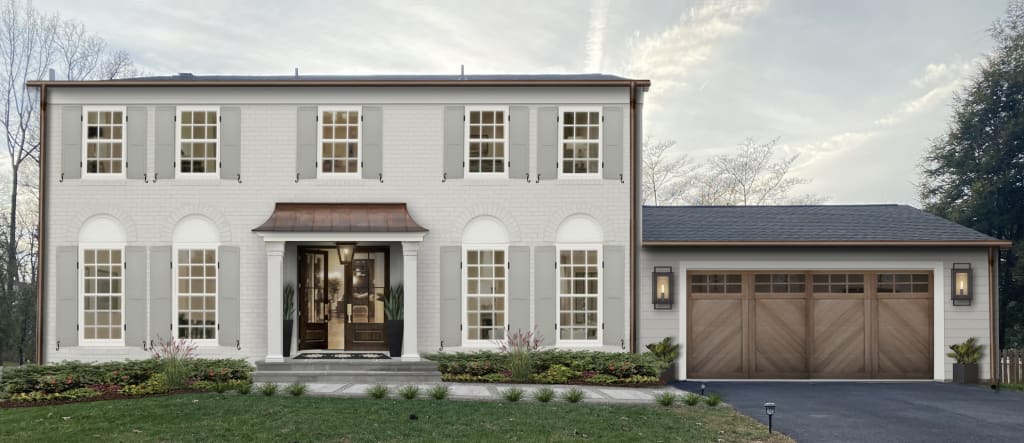 light gray brick home with shutters and copper gutters