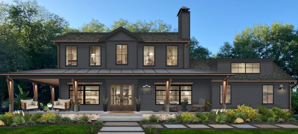 large transitional two story home painted in dark blue gray with a large wraparound porch