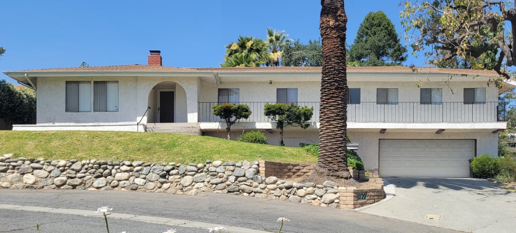 A before photo of a stucco home in California