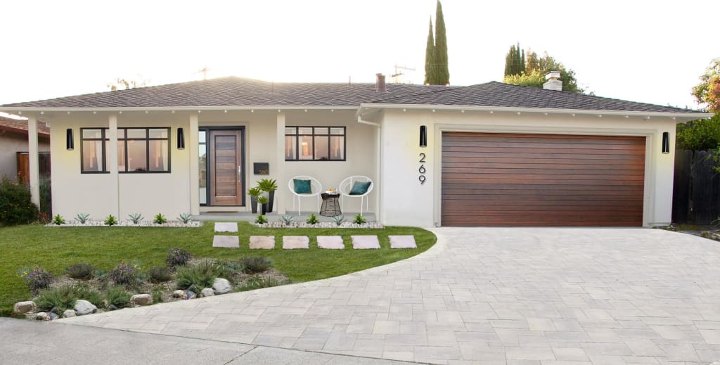 white painted modern spanish rustic ranch with grid pattern windows and wood garage door