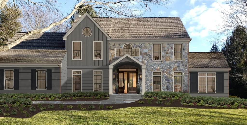 A completed stone home is partially painted with James Hardie Hardie Board siding color Aged Pewter, a peaceful gray color. The home has a beautiful front yard with lush landscaping, and a covered front entry that leads inside.