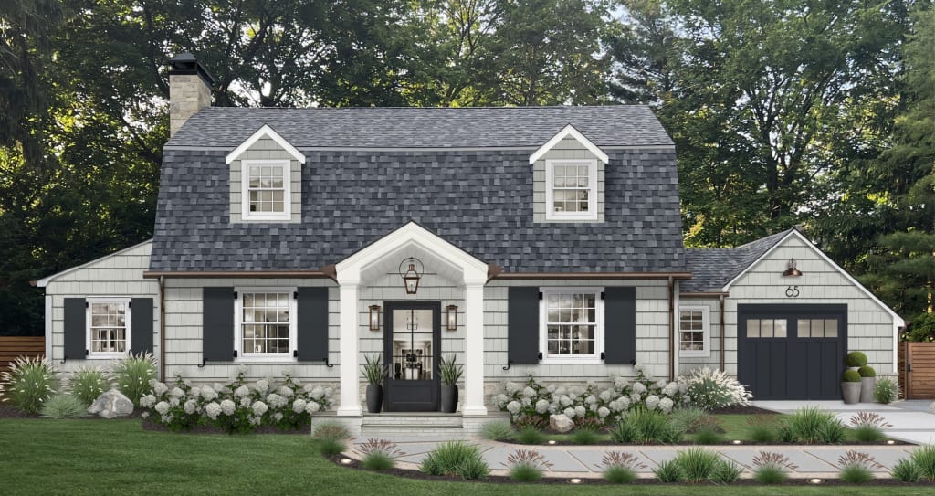 light gray cape cod style home with charcoal shutters and garage door