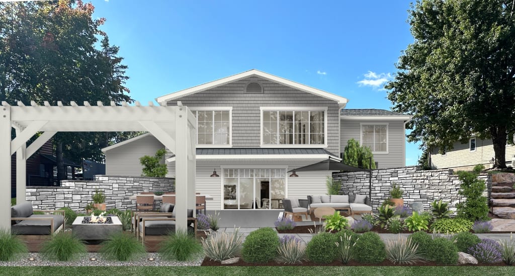 Large pergola with a lounge area and fire pit in the backyard of a two story home.