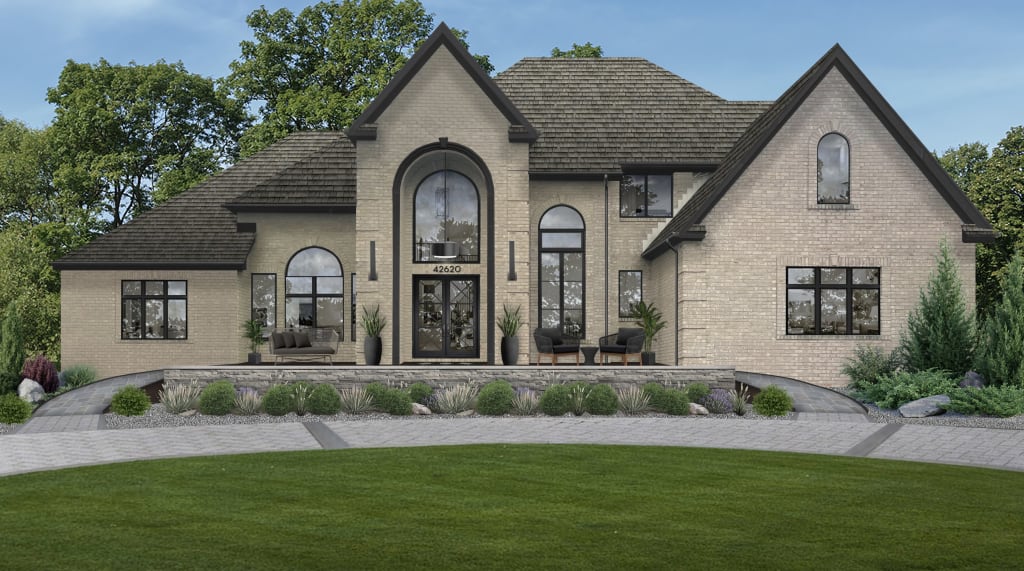 brown brick home with multiple peaked roofs and curved entrance with quoin design
