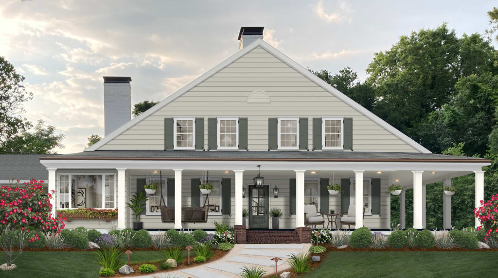 Modern farmhouse with green shutters, white columns, and a large porch with lounge area.