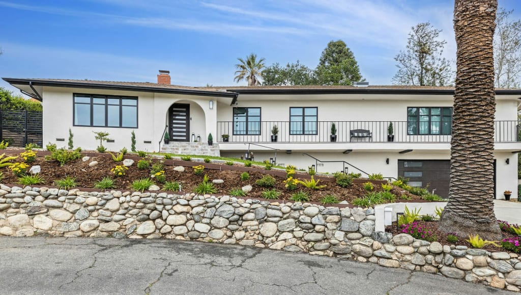 White house with black windows in California completed front façade