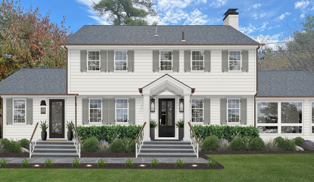 Traditional farmhouse with sage green shutters, black front door and accents, with minimal landscaping.