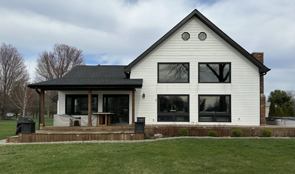 The side of a lake house with white siding