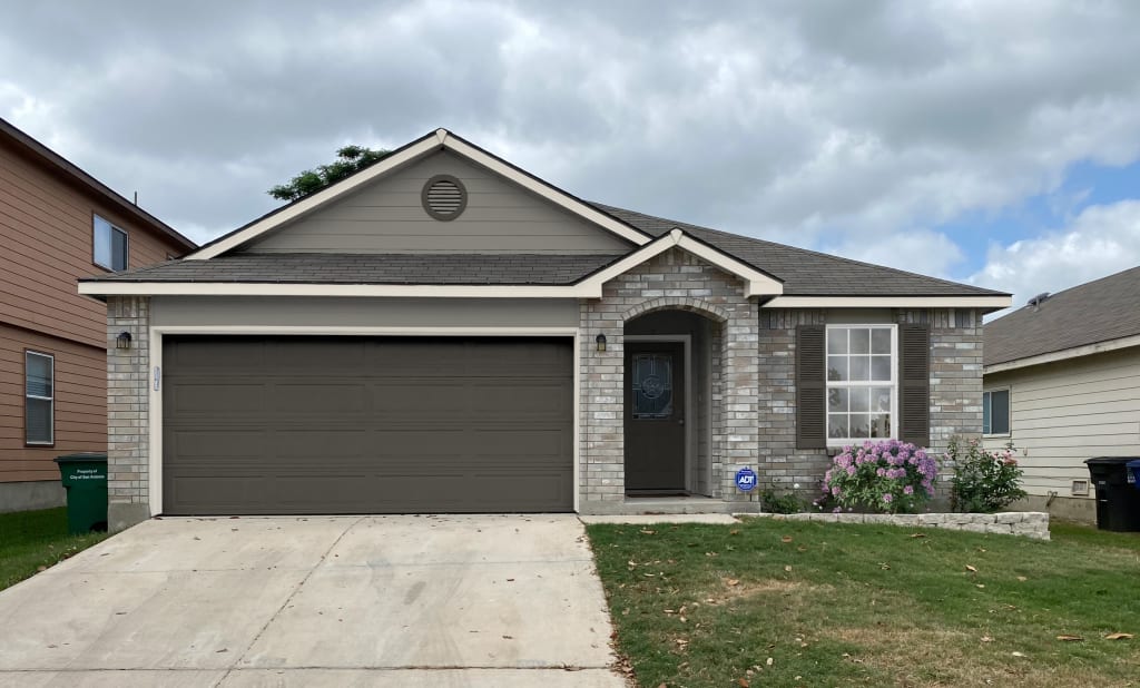 Photorealistic rendering of a home exterior featuring gray and stone siding.