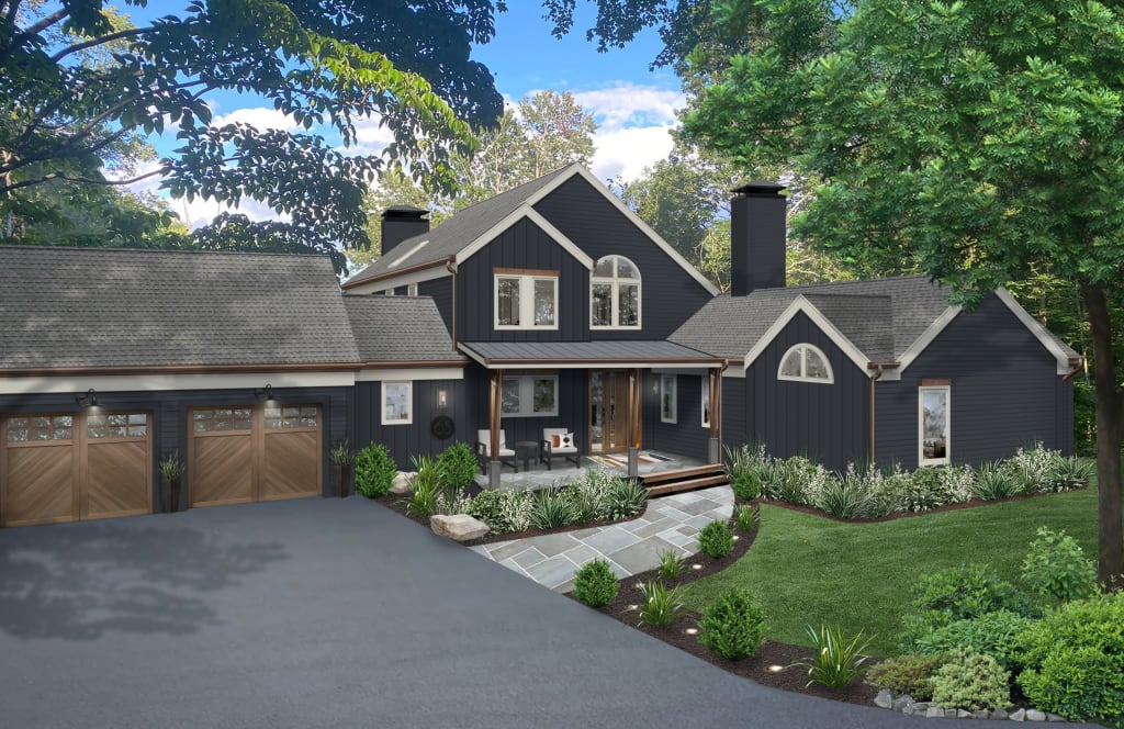 Two-story home in wooded setting with dark siding