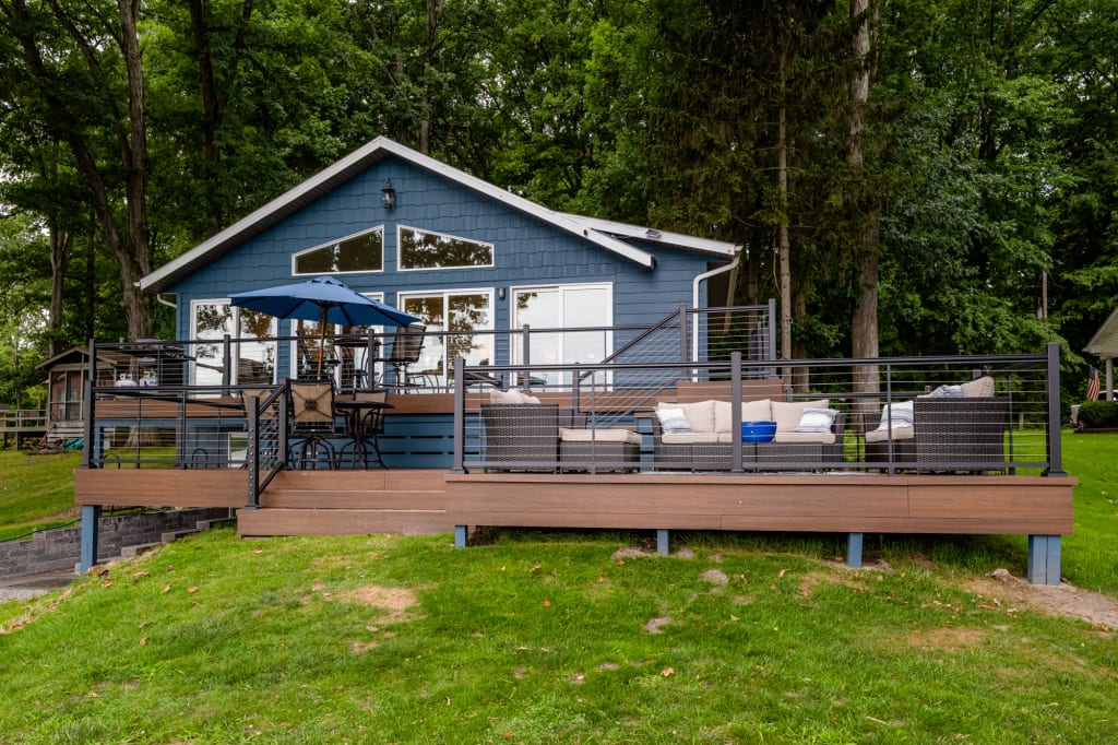 Michigan lake house exterior design completed with siding in Newburg Green