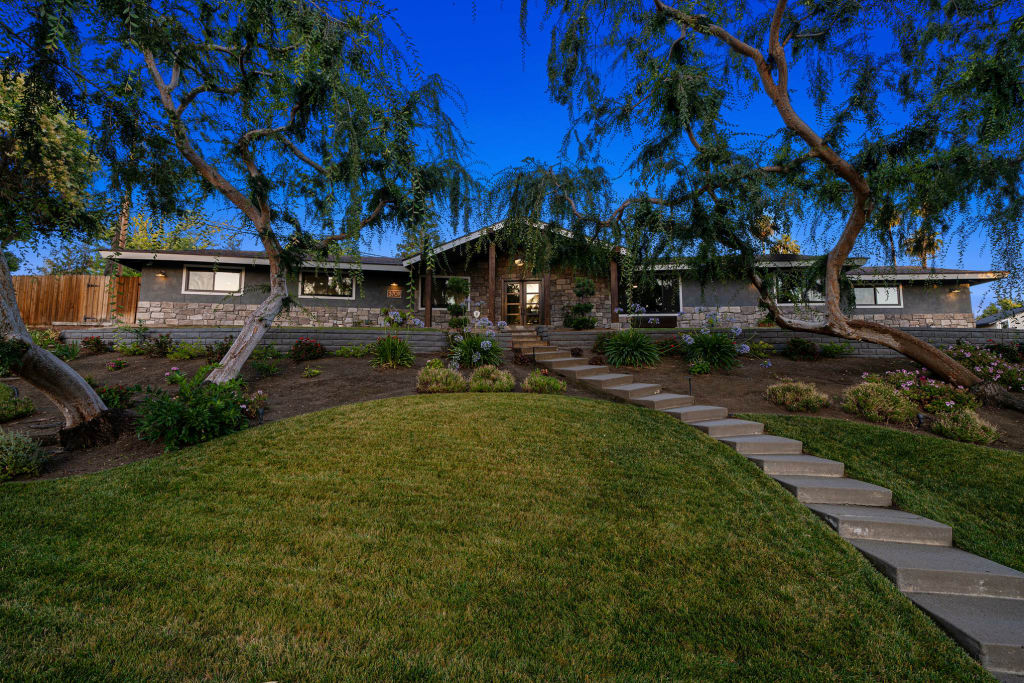 Michael's renovated rambler house features a stone path, stone siding and gray and greige paints.
