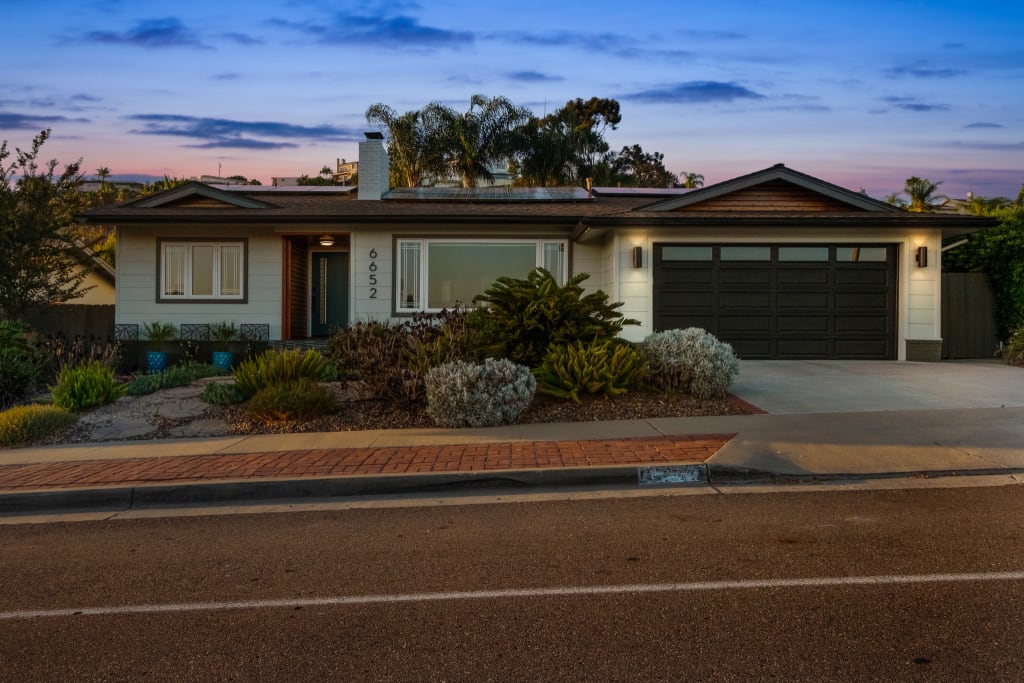 An after photo of a modern black and white ranch house