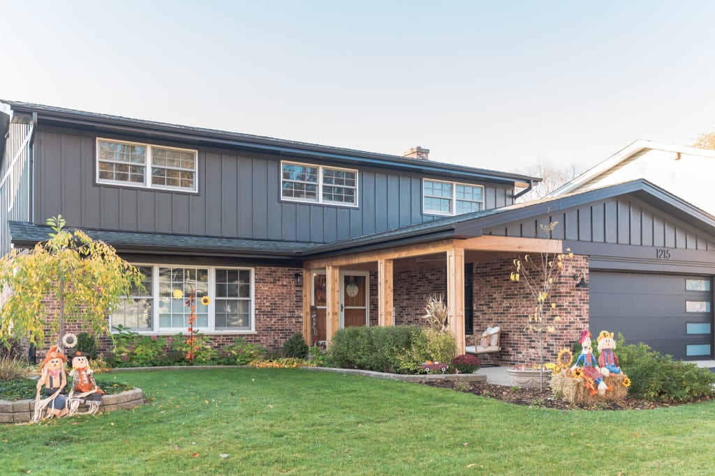 A home featuring new board and batten siding with brick