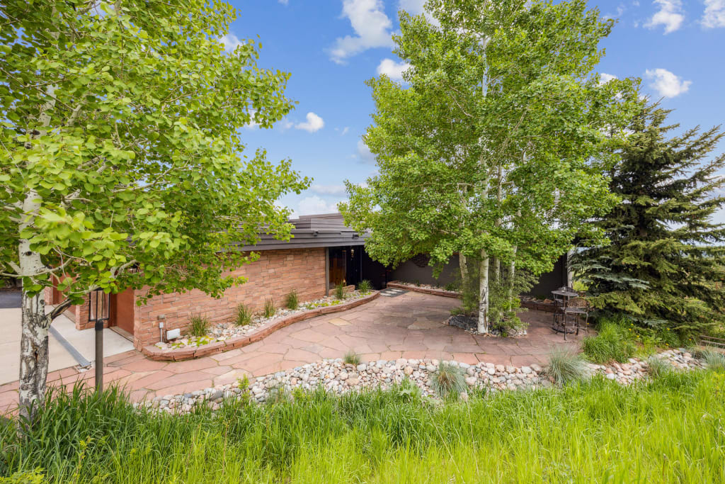 An actual after photo of a Colorado home with dark siding and natural stone