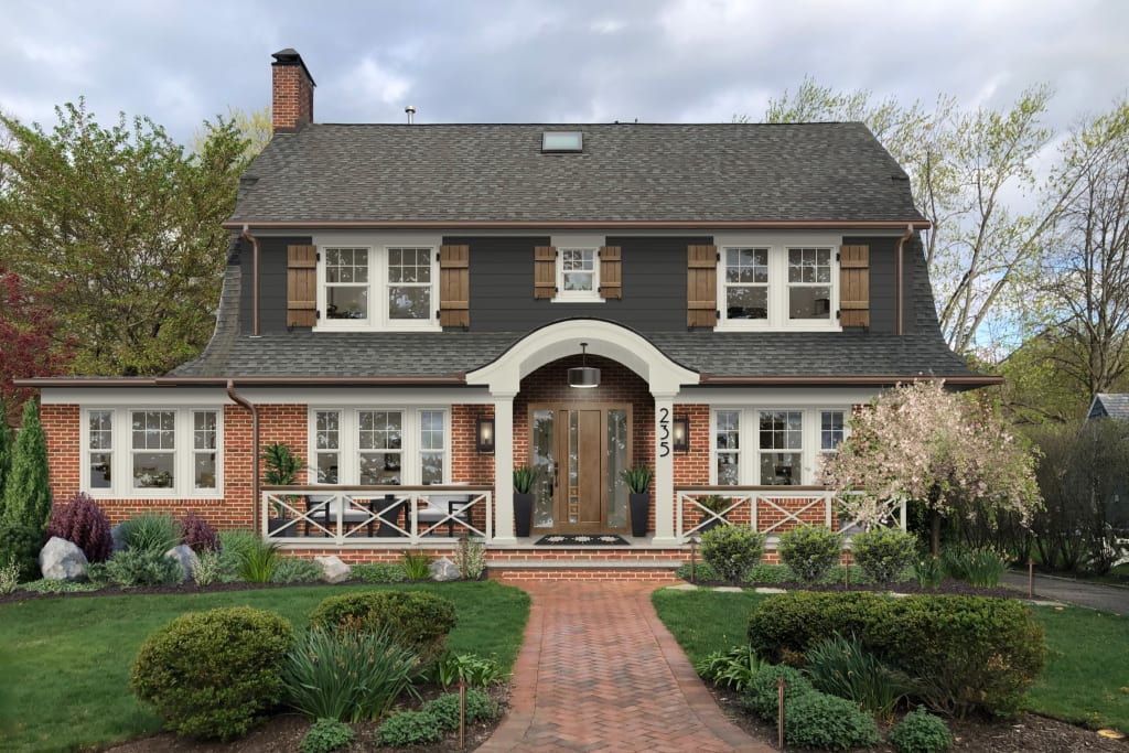 traditional home with red brick, white trim, wood shutters, and a brick walkway
