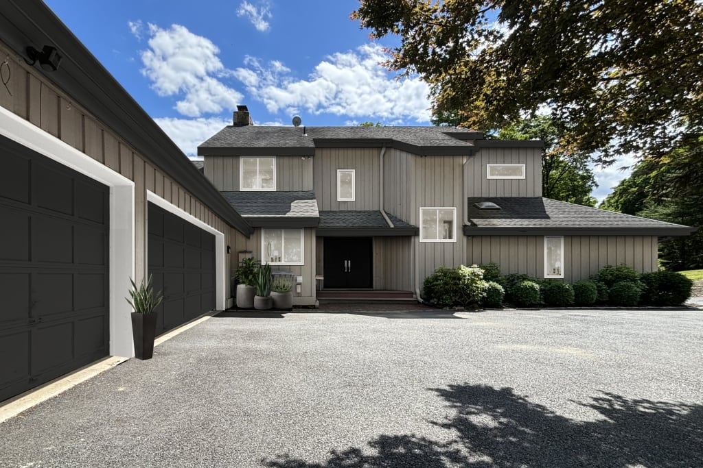 Modern, L-shaped home exterior with a neutral color palette.