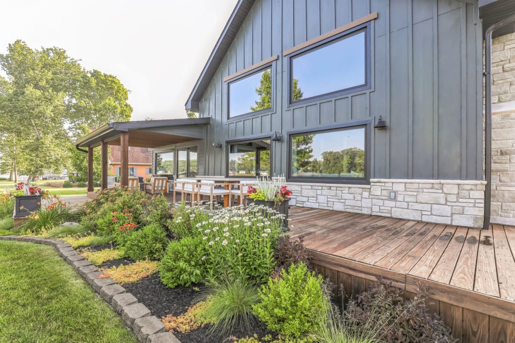 A home with dark siding and a wood deck