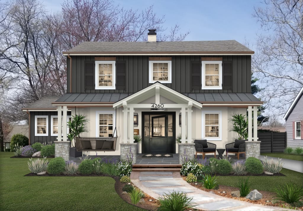 Two-story black and white farmhouse with outdoor seating and copper gutters