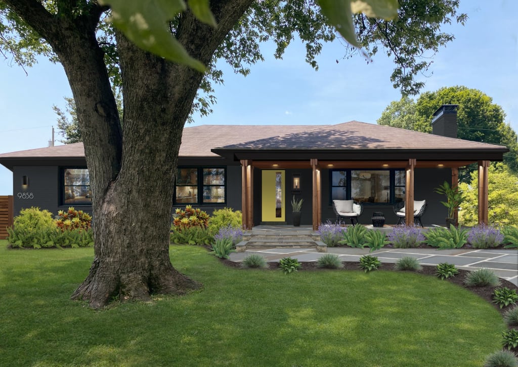 Dark gray modern ranch home with bright yellow door and side porch