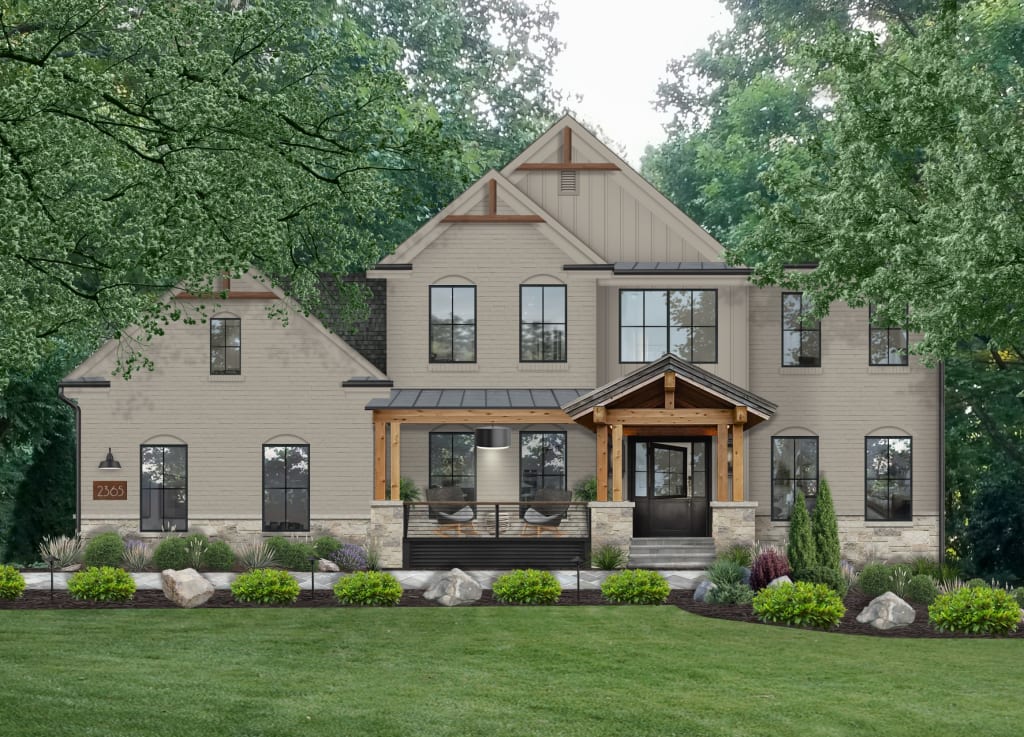 a brown-gray two story farmhouse with cedar columns and portico, black windows, rock and shrub landscaping, and stone cladding.
