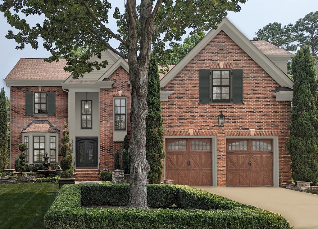 red brick house with greige accents and dark shutters