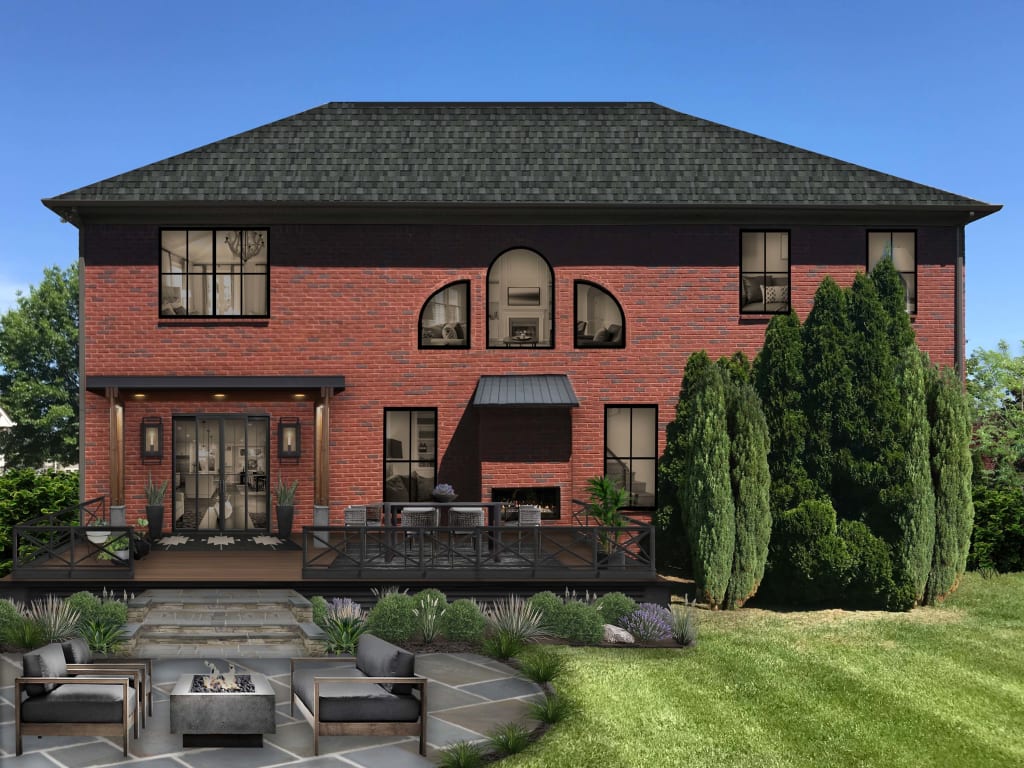 red brick home with black accents and a firepit with seating