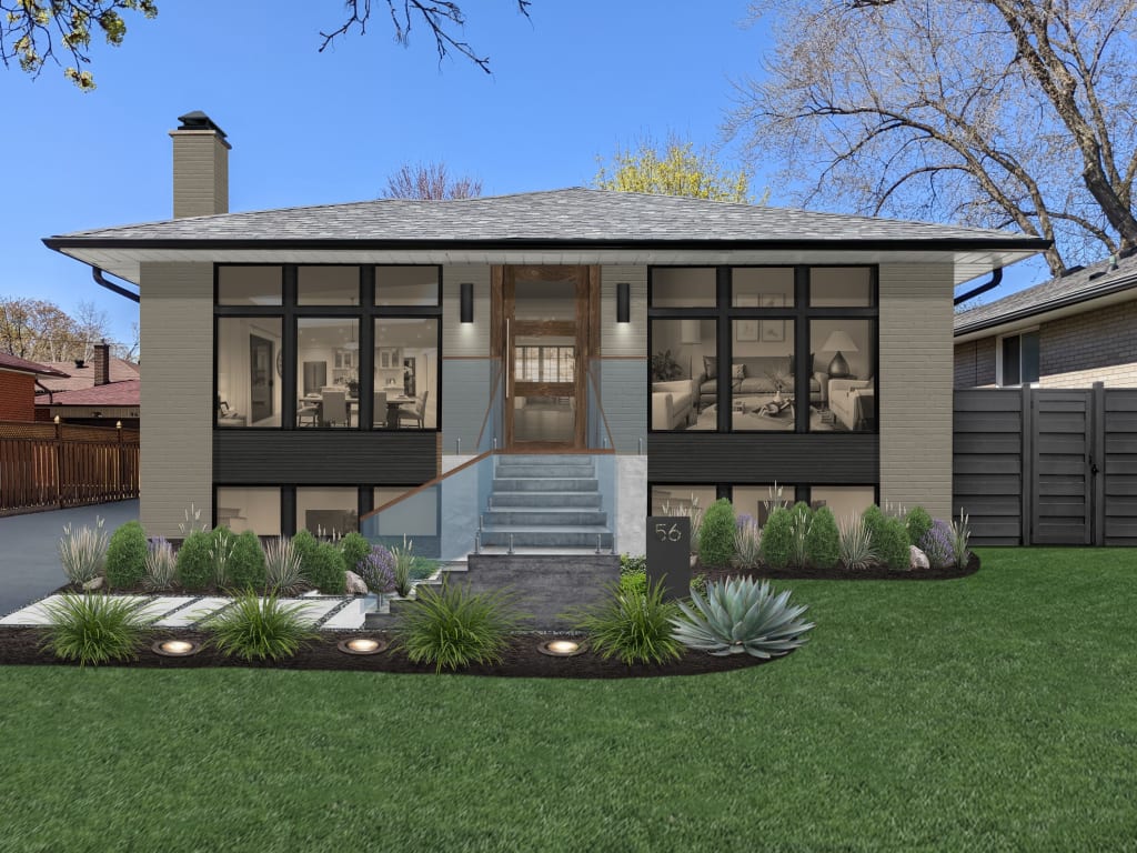 A green-gray contemporary home with glass railing, tall black windows, minimal landscaping, and a stone-and-paver walkway