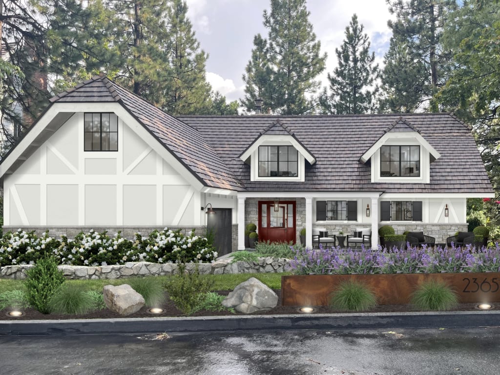 Exterior of a quaint, two-story cottage home with beautiful landscaping.