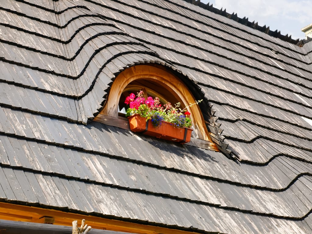 A home with eyebrow dormers, one of the unique design words our clients taught us