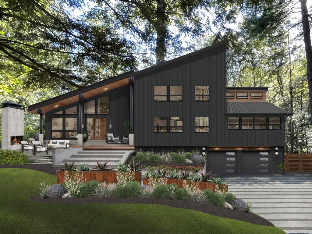 A modern home with a slanted roofline, wood accents, black windows, and a modernized driveway.