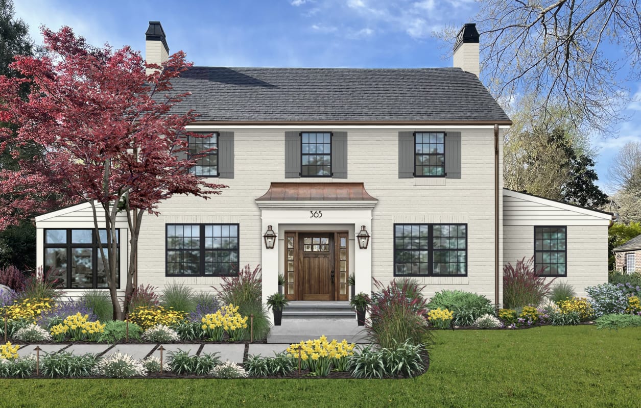 Two story home featuring a portico with a copper awning